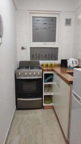 a kitchen with a stove and a window in it at Departamento centro mdp calle belgrano in Mar del Plata