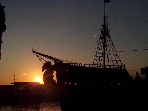 a boat sitting in the water at sunset at Dar Baaziz in Sousse