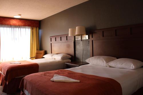 a hotel room with two beds and a window at LA VISTA INN in Port Richey