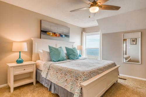 a bedroom with a bed with a view of the ocean at Tybee Lights in Tybee Island