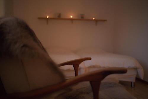 a living room with a chair and two beds at Lapland Stuga & Tours in Rentjärn