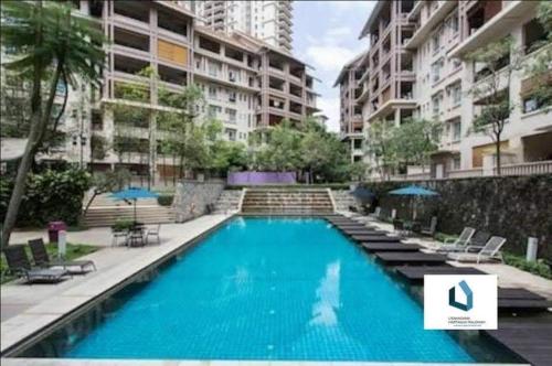 a large swimming pool in the middle of a building at Seri Maya -Lrt setiawangsa - Master Room with shared unit in Kuala Lumpur