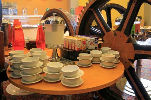 a group of cups and saucers on a table at Holiday Inn Monterrey-Parque Fundidora by IHG in Monterrey