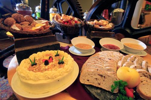 a table with bread and a cake and other foods at Holiday Inn Monterrey-Parque Fundidora by IHG in Monterrey
