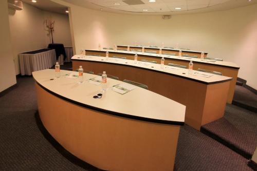 a large room with a large white counter with chairs at Holiday Inn Monterrey-Parque Fundidora by IHG in Monterrey