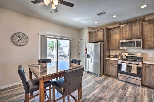 a kitchen with a table and chairs and a refrigerator at Pet-Friendly Retreat - 1 Block to Colorado River! in Bullhead City