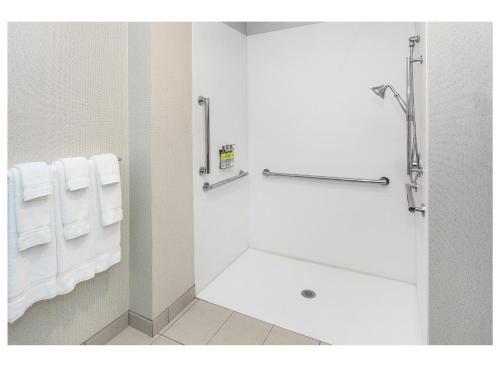 a bathroom with white towels and a bath tub at Holiday Inn Express & Suites - Hudson I-94 by IHG in Hudson