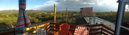 una casa dotata di balcone con sedie e piscina. di Tierras de Shiva a Valle Hermoso