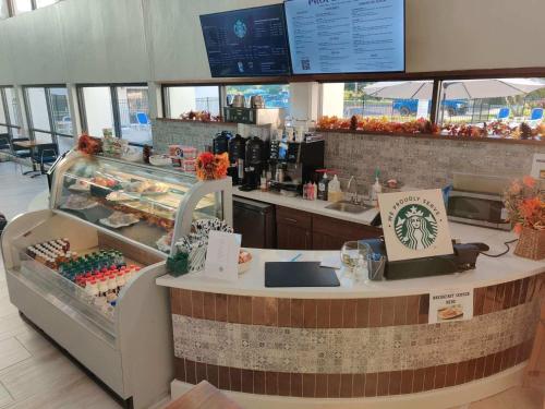 a food counter in a restaurant with a counter at Crowne Plaza Jacksonville Airport, an IHG Hotel in Jacksonville