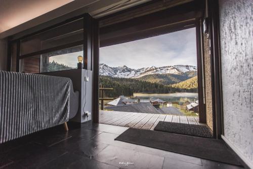 a room with a large window with a view of a mountain at Gîte Le Petit Arbizon in Campan