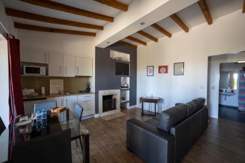 a living room with a couch and a table at Apartamentos Rurais - Casas do Lagar in Rosmaninhal