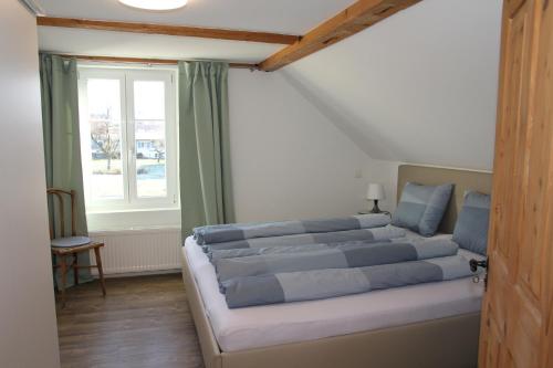 a large bed in a room with a window at Ferienhaus Kluser in Oberriet