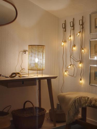 a room with a table and lights on the wall at The Island Place in Bol