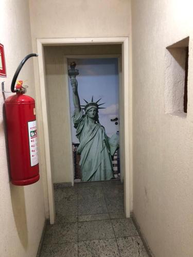 a fire hydrant in front of the statue of liberty at Zen Garden Hostel Mirandópolis in Sao Paulo
