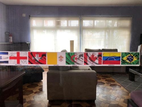 a room with a table with different flags on it at Zen Garden Hostel Mirandópolis in Sao Paulo
