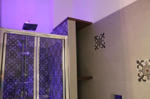 a bathroom with a shower with purple lighting at Toledo Point in Naples
