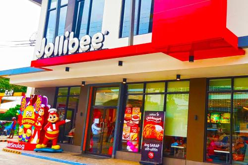 a jollibee store with a sesame street sign on the facade at Mactan Newtown - New Modern Condo with Ocean View in Mactan