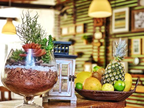 a vase filled with fruits and vegetables on a table at Villa Medina Jeri in Jericoacoara
