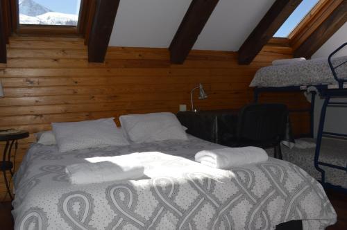 a bedroom with a bed with towels on it at Pensión Panticosa in Panticosa
