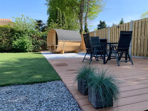 a patio with chairs and a hot tub in a backyard at Liv Residence Holiday Home with Sauna & Fireplace in Ermelo