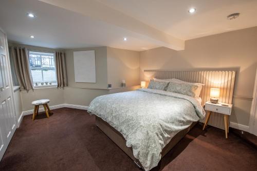 a bedroom with a large bed and two lamps at 25 Church Street in Keswick