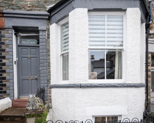 a house with a blue door and a window at 25 Church Street in Keswick