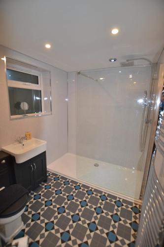 ein Bad mit einer Dusche und einem Waschbecken in der Unterkunft Mayflower 2 bed Boutique Apartment - STAYSEEKERS in Salisbury