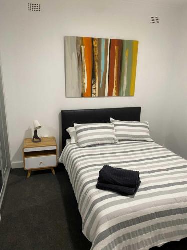 a bedroom with a bed and a painting on the wall at Adelaide Brownhill Creek Tourist Park in Adelaide