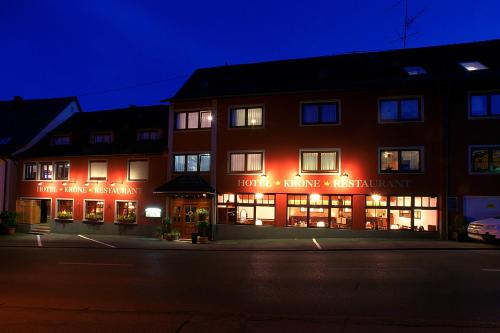 a building with red lights on a street at night at Hotel Krone in Haigerloch
