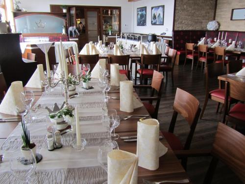 a dining room with a long table and chairs at Hotel Krone in Haigerloch