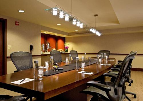 a conference room with a large wooden table and chairs at Crowne Plaza - Chicago West Loop by IHG in Chicago