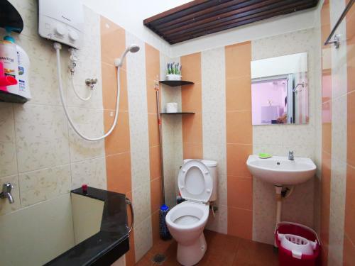 a bathroom with a toilet and a sink and a shower at Bagan Terrace House near to Sunway Carnival Mall, Seberang Jaya in Butterworth