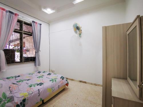 a bedroom with a bed and a window at Bagan Terrace House near to Sunway Carnival Mall, Seberang Jaya in Butterworth