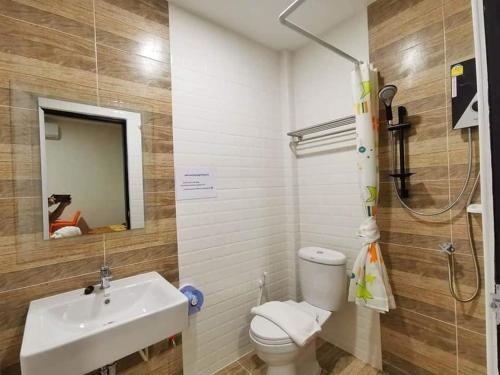 ein Badezimmer mit einem Waschbecken, einem WC und einem Spiegel in der Unterkunft PP Nongkhai Resort in Nong Khai