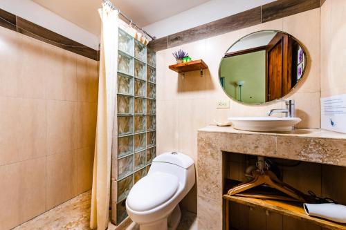 a bathroom with a toilet and a sink at Villa Nautilus in Tamarindo