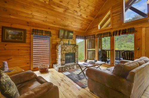 a living room with a couch and a fireplace at Spacious Cubby Bear Cabin in Sevierville