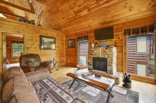 a living room with a couch and a fireplace at Spacious Cubby Bear Cabin in Sevierville