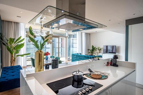 a kitchen with a stove and a counter top at Nasma Luxury Stays - Blue Waters Island in Dubai