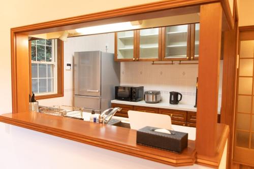 a kitchen with a counter top and a refrigerator at 青庭 in Ito