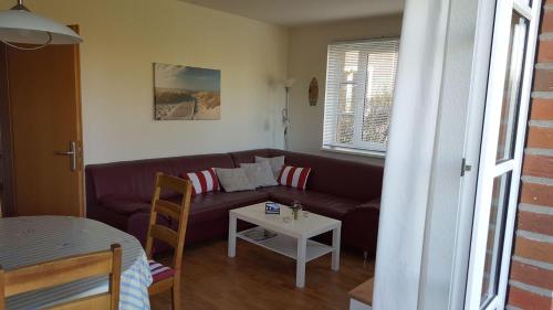 a living room with a couch and a table at GODS06002-FeWo-bie-de-Reede in Gollendorf