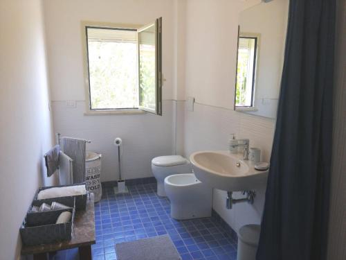 a bathroom with a sink and a toilet and a mirror at Casa Romeo in Taormina