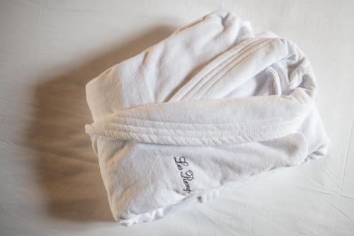 a white towel sitting on top of a table at Les Remparts Hôtels et Demeures Historiques in Beaune