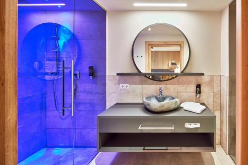 HOTEL SONNBLICK Kaprun, Salzburg - including Summer Card في كابرون: حمام مع حوض ومرآة