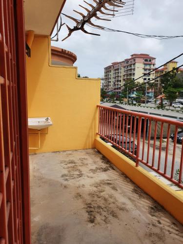 uma varanda de um edifício com uma parede amarela em Ten Inn em Kuala Terengganu