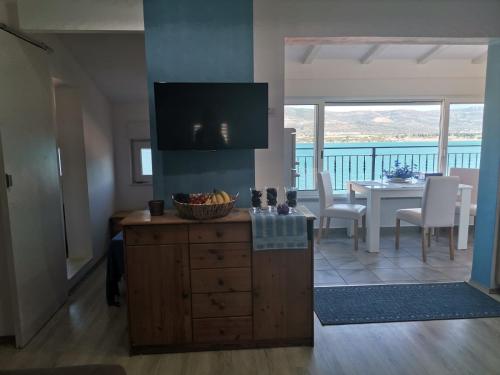 a kitchen and dining room with a view of the ocean at Blue View Apartments in Trogir