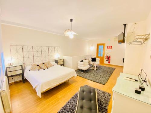 a bedroom with a bed and a living room at Chinchonspa in Chinchón