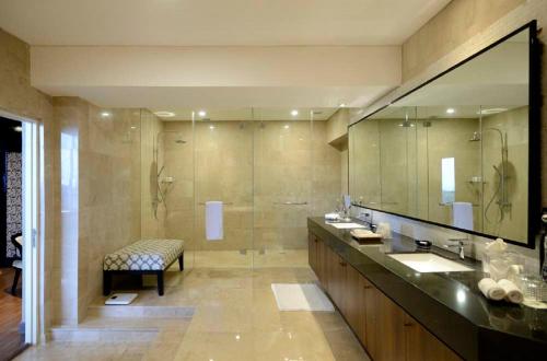 a large bathroom with two sinks and a shower at Discovery Ancol in Jakarta