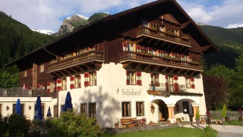 a large building with two balconies on top of it at Schlosswirt Chalets & Apartments in Großkirchheim