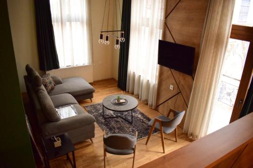 a living room with a couch and a table at Boutique Hotel St Nikolas by Skar in Kruševo