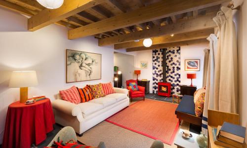 a living room with a white couch and a red chair at Kentmere Hall Bank Barn in Kentmere